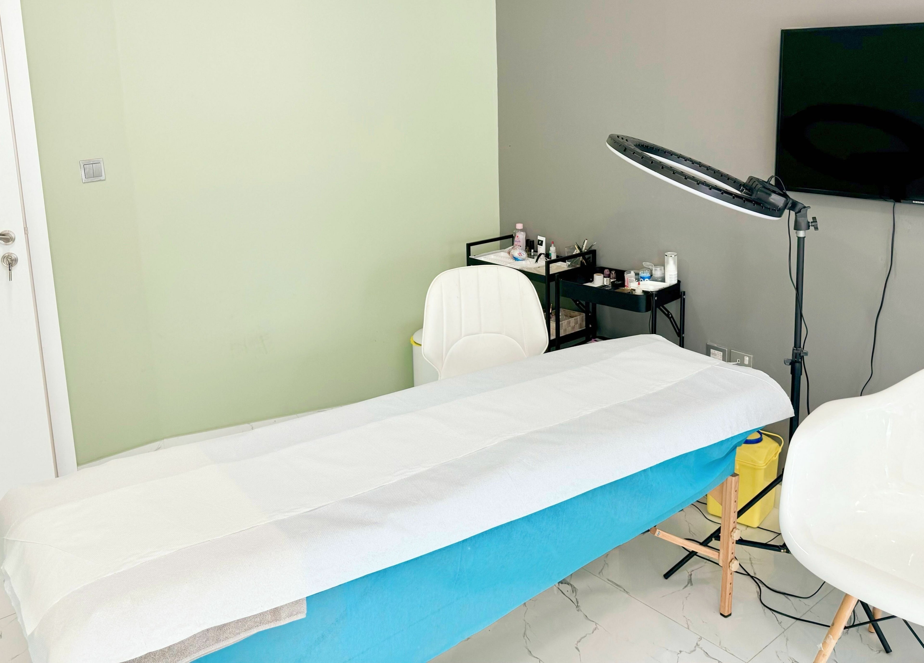 Treatment room at Sunface Medical Aesthetic Center, Dubai, Dubai, AE, featuring a comfy bed and modern setup.