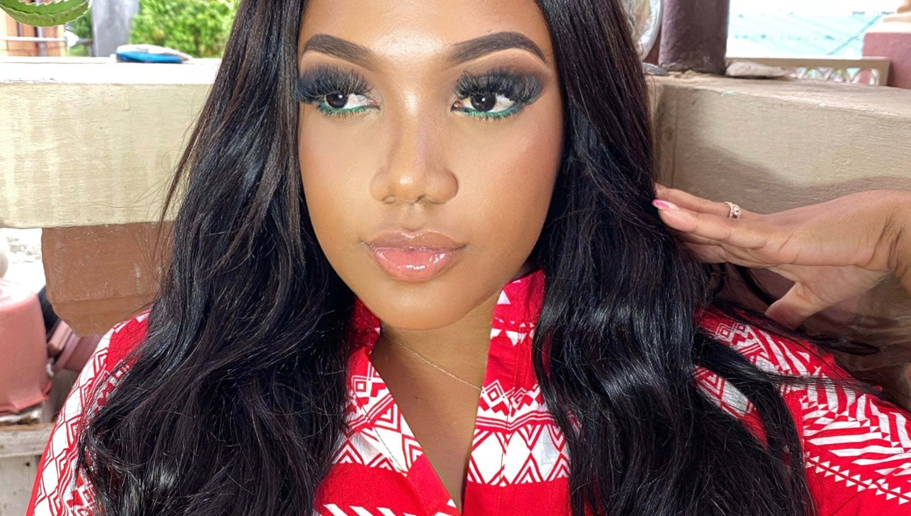 Glamorous woman in a red patterned top at Shumabelle, Willemstad, Curaçao, CW.