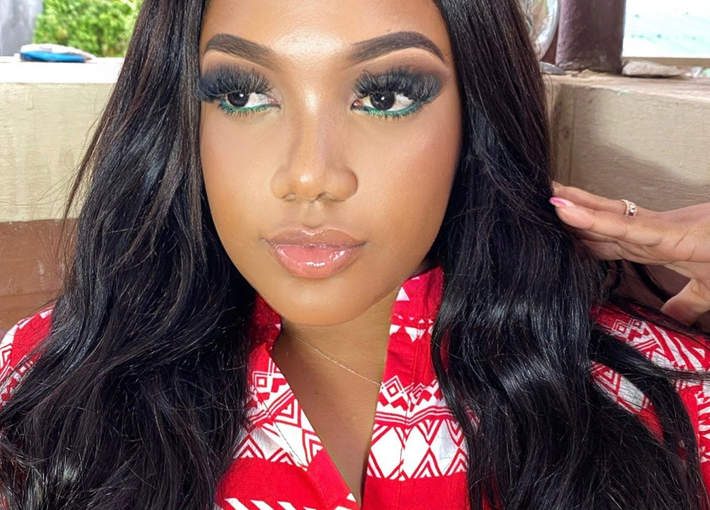 Glamorous woman in a red patterned top at Shumabelle, Willemstad, Curaçao, CW.