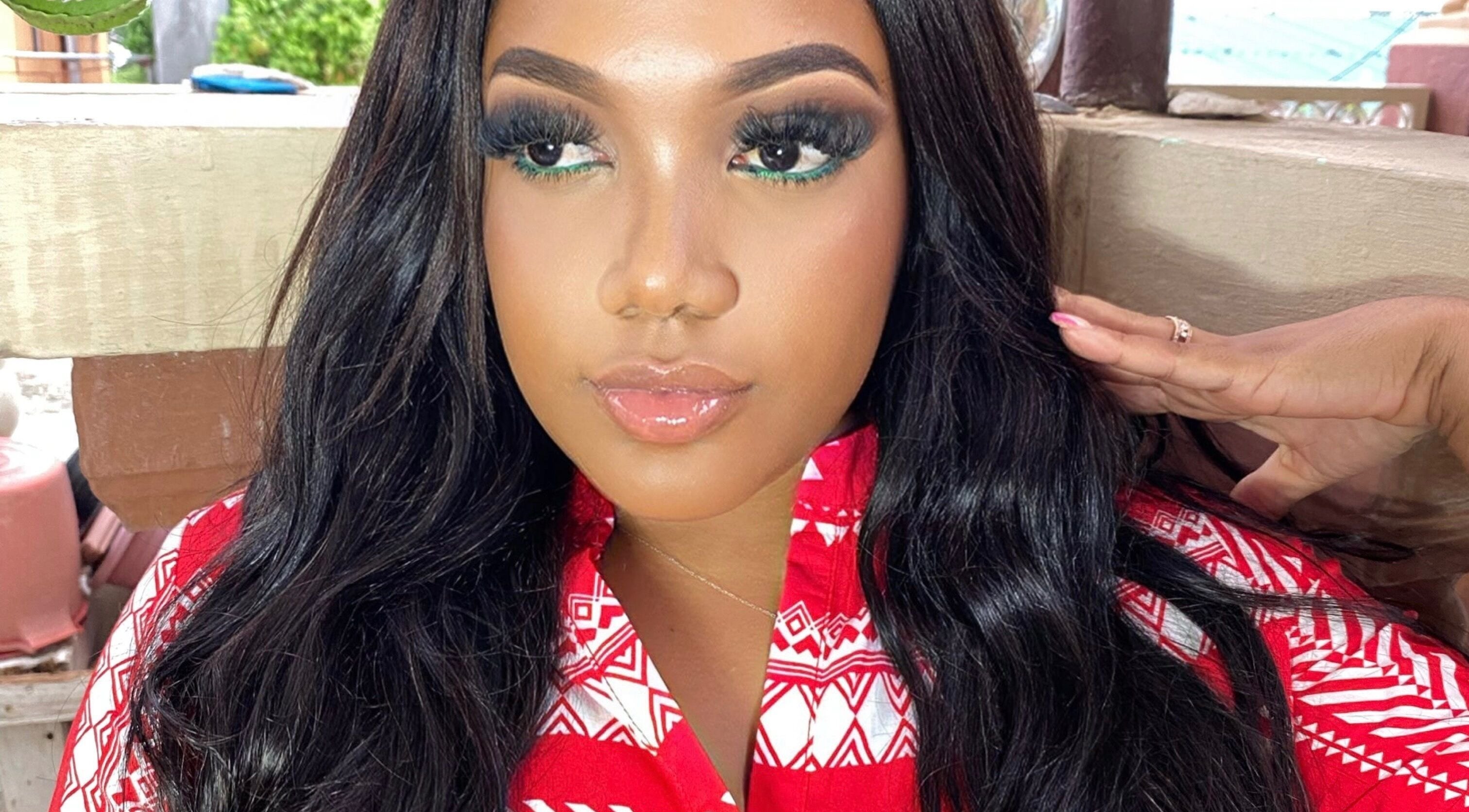 Glamorous woman in a red patterned top at Shumabelle, Willemstad, Curaçao, CW.