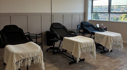 Tranquil treatment room at StudioS by Sienna in Stoke-on-Trent, England, GB, featuring cozy chairs and large windows.