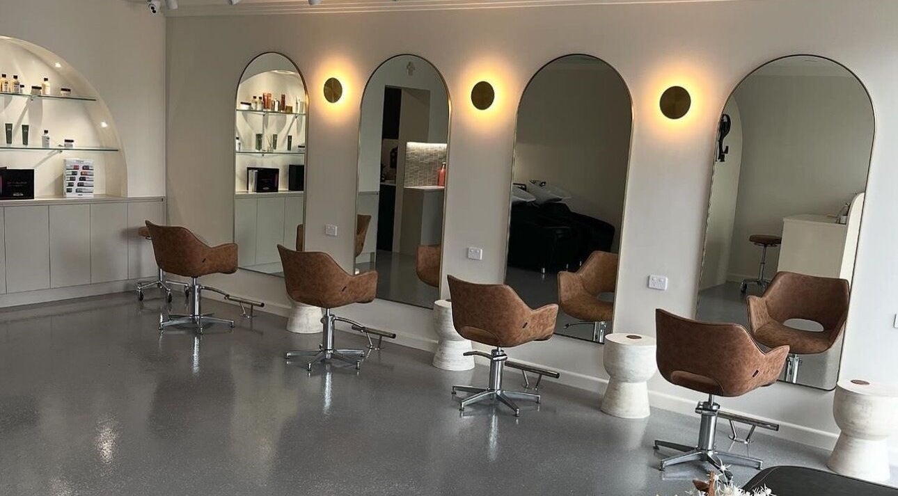 Chic interior of Stefanie Napoleone Hair, Peakhurst, New South Wales, AU, with stylish salon chairs and mirrors.