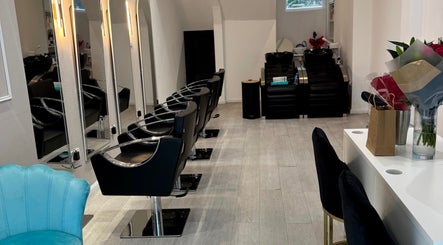 Elegant interior of S&M Beauty Lounge, London, England, showcasing modern styling chairs and mirrors.