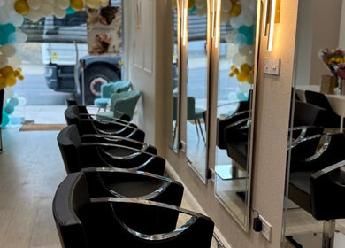 Modern interior of S&M Beauty Lounge, London, England, GB with elegant mirrors and stylish black chairs.