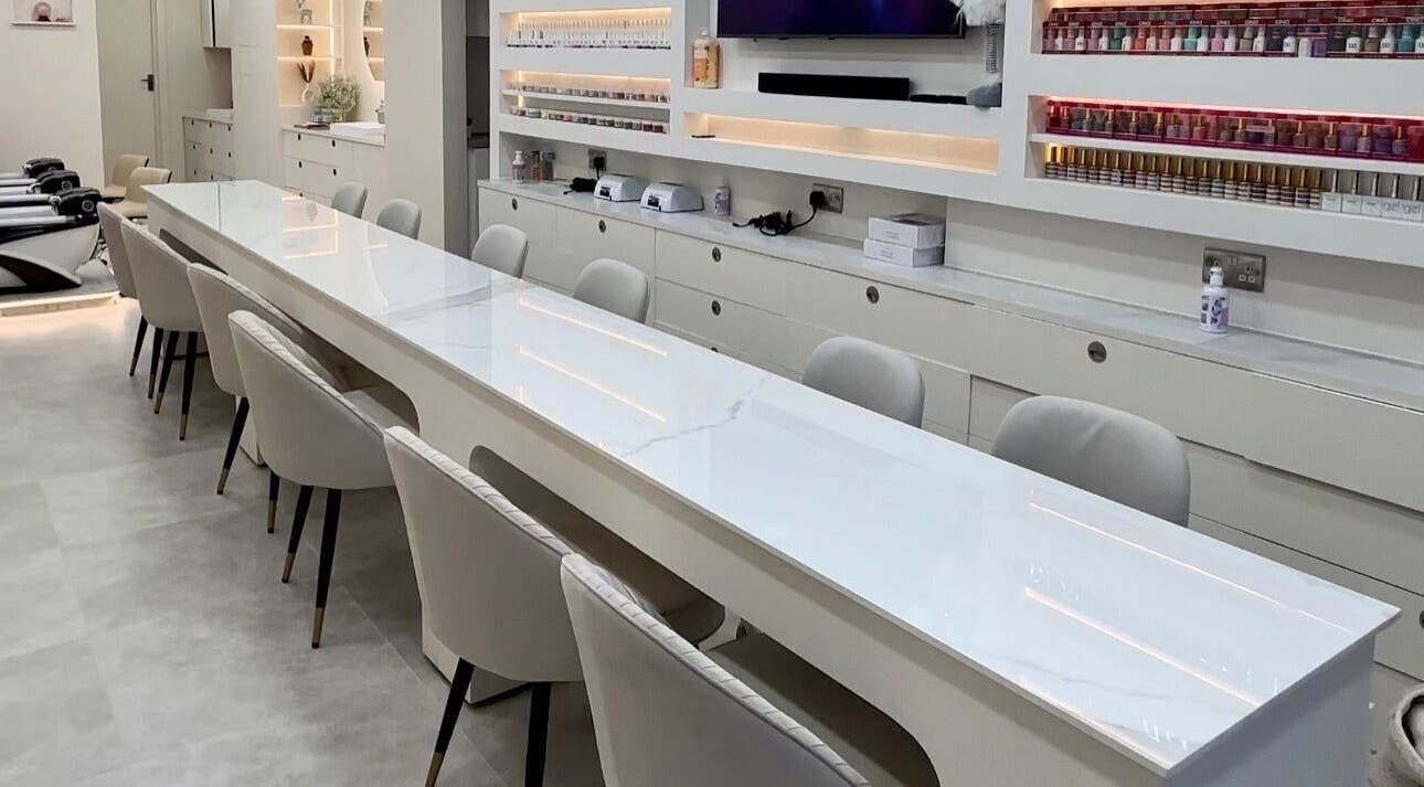 Sleek white nail stations at DP Nail Spa, London, England, GB, showcasing a modern and inviting atmosphere.