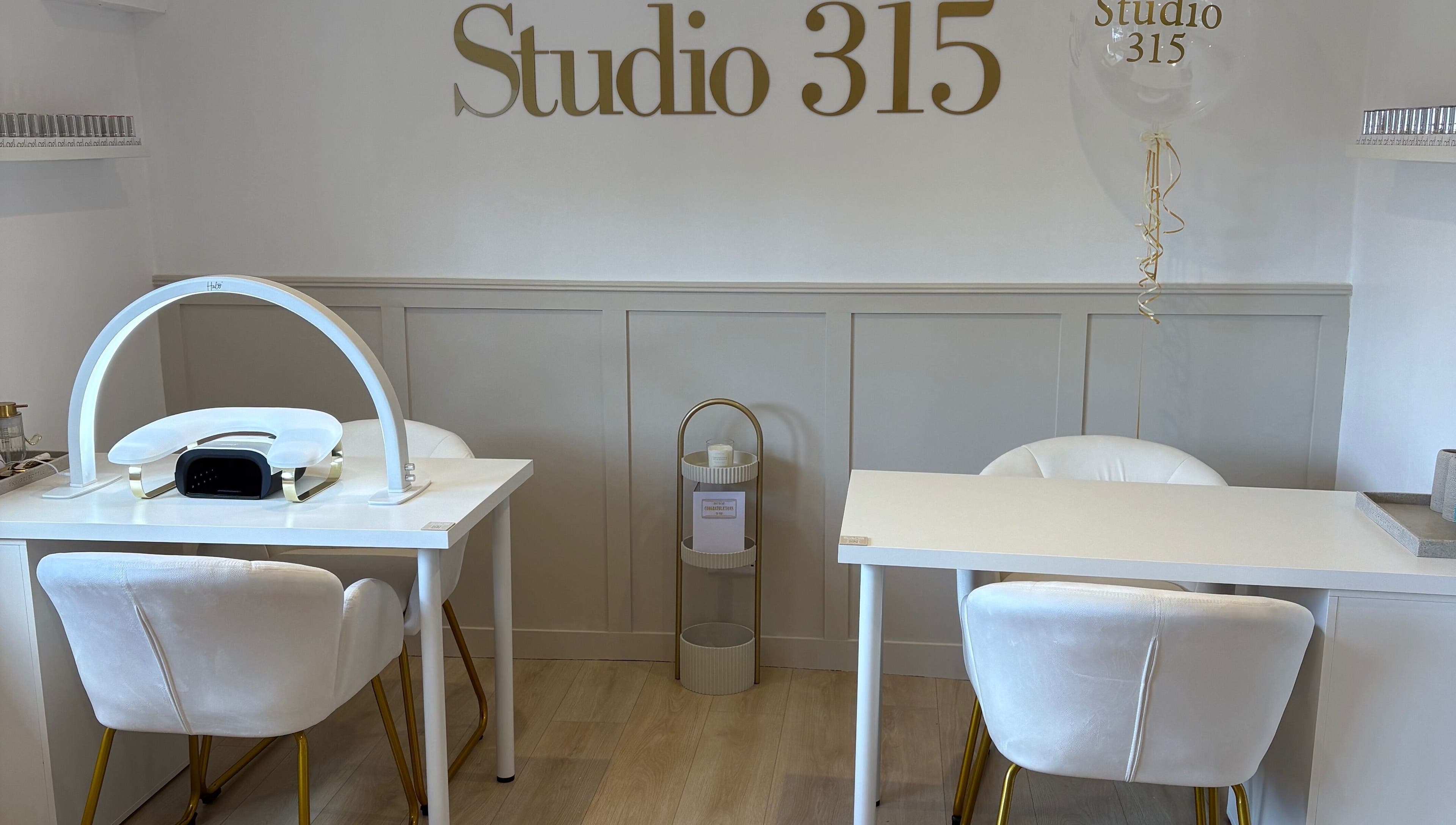 Modern nail station at Nails By Els, Busby, Scotland, GB featuring sleek white decor and luxury seating.