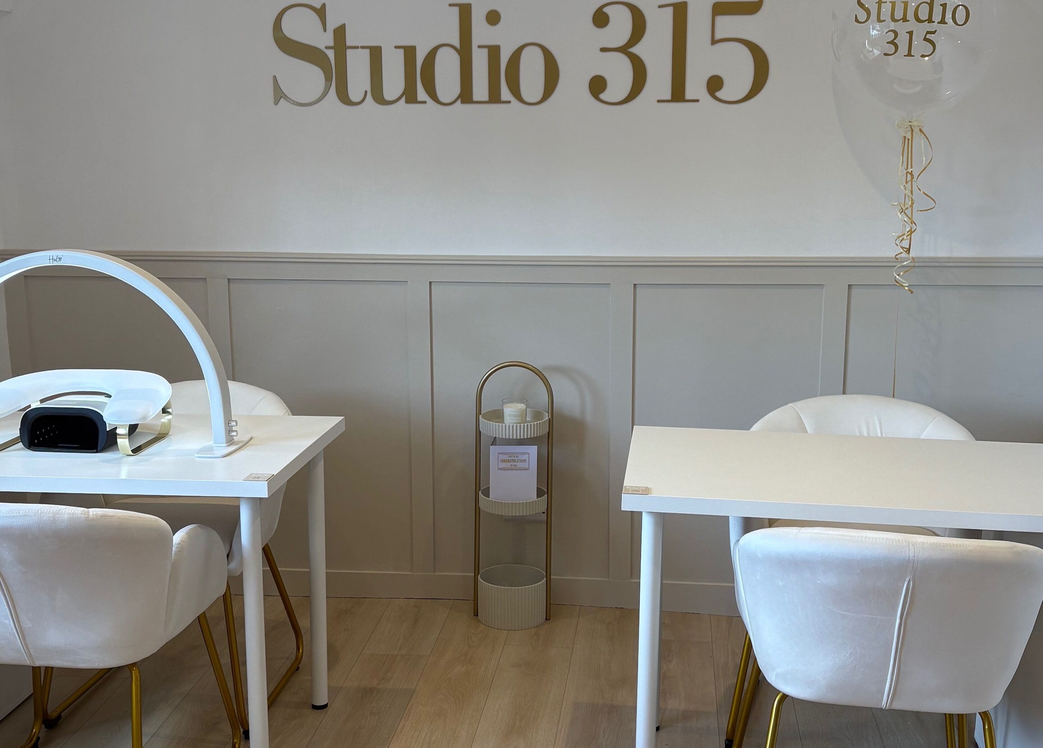 Modern nail station at Nails By Els, Busby, Scotland, GB featuring sleek white decor and luxury seating.