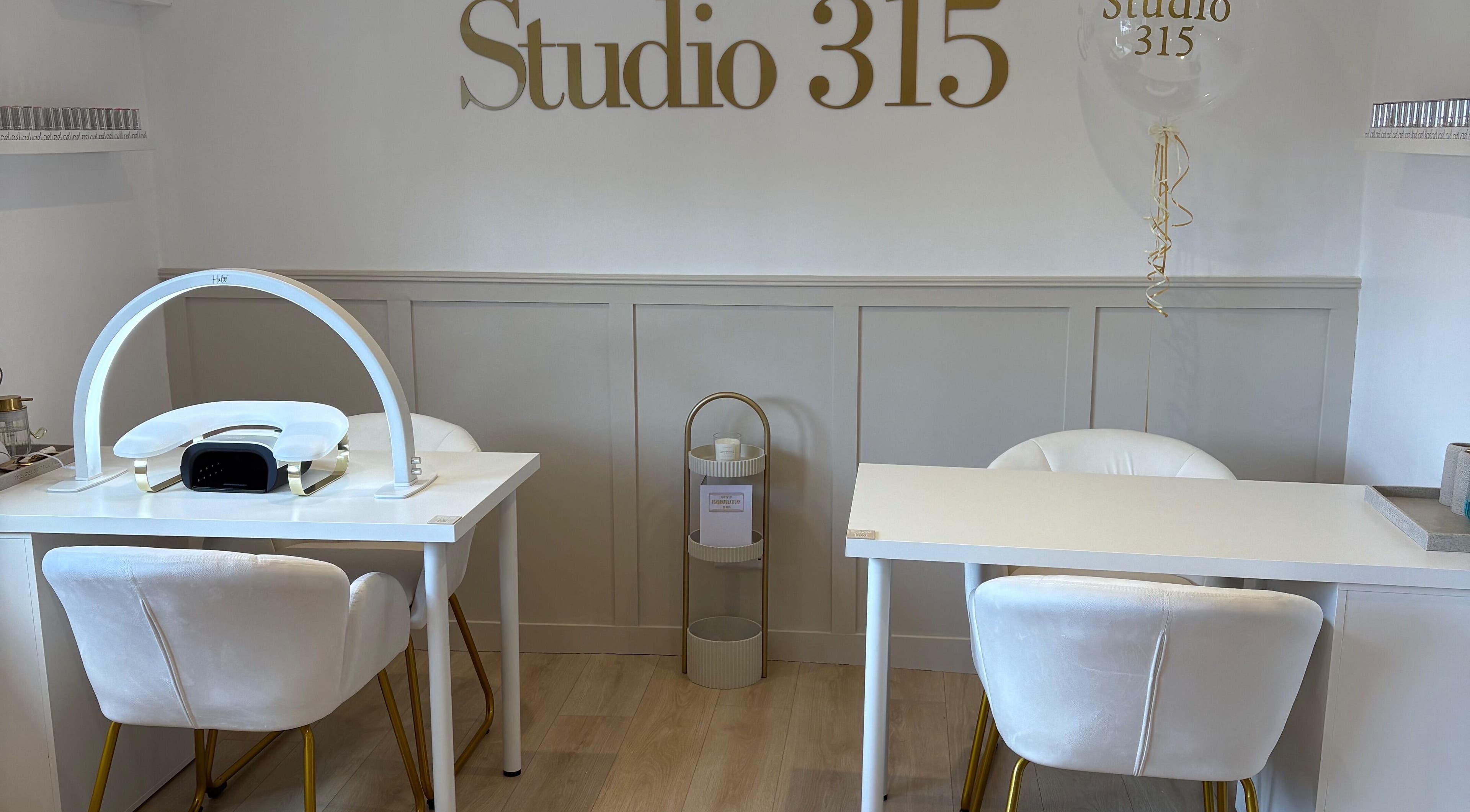 Modern nail station at Nails By Els, Busby, Scotland, GB featuring sleek white decor and luxury seating.