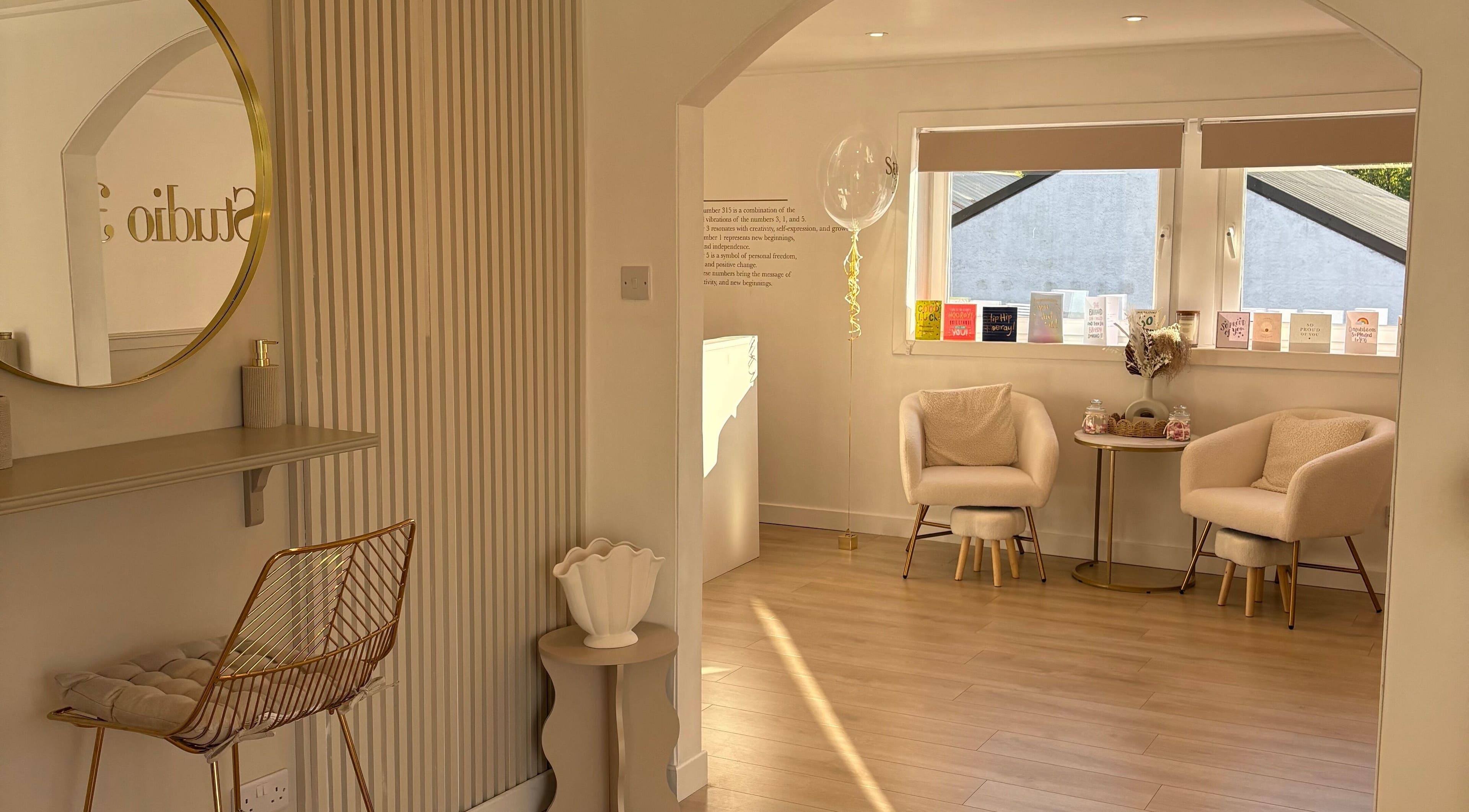 Chic seating area at Nails By Els in Busby, Scotland, GB with plush chairs and artistic decor.