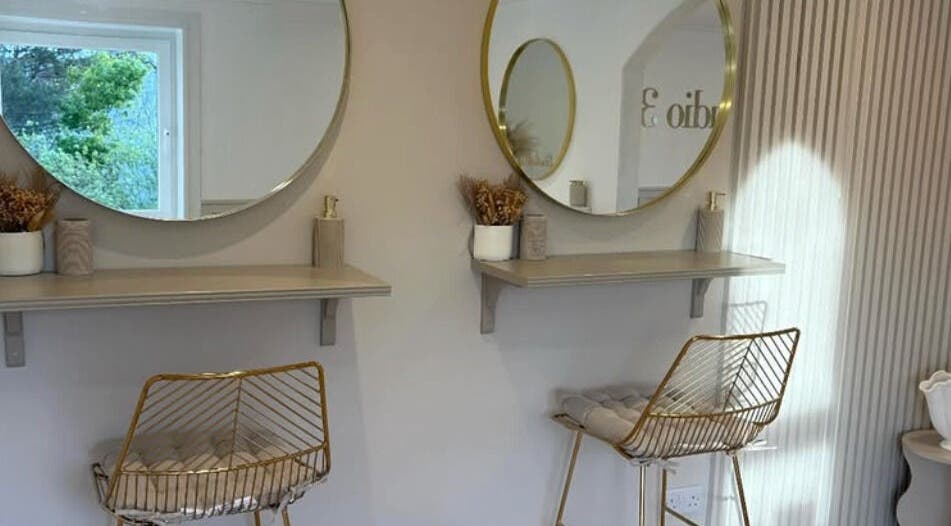 Chic beauty setup at Nails By Els, Busby, Scotland, GB with stylish seating and elegant mirrors.