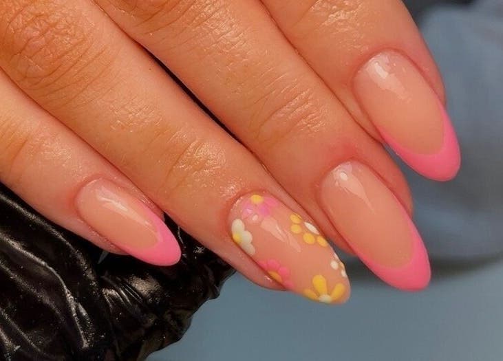 Floral nail art with pink tips at Nails By Els, Busby, Scotland, GB. Perfectly manicured nails displayed.