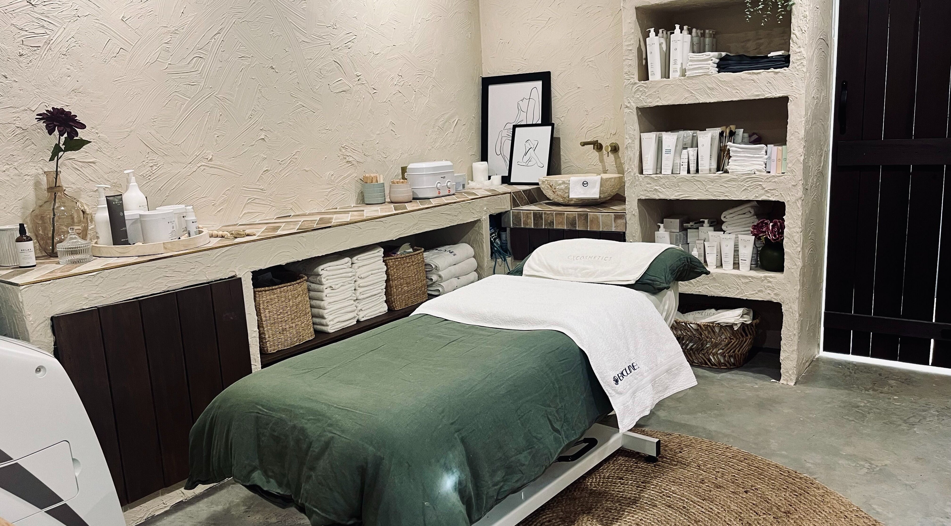 Relaxing spa room at High Maintenance Heaven, Yerrinbool, NSW, AU with a bed and natural decor.