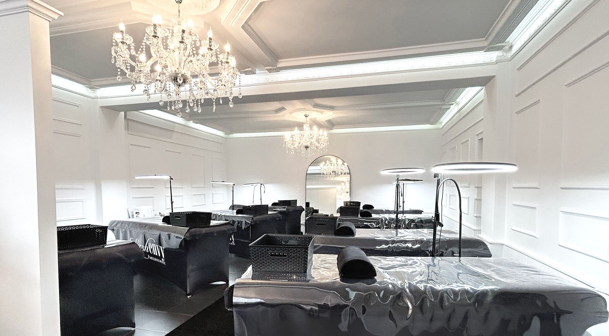 Elegant interior of Lash Envy | Oakleigh with plush beds and chandeliers in Oakleigh, VIC, AU.