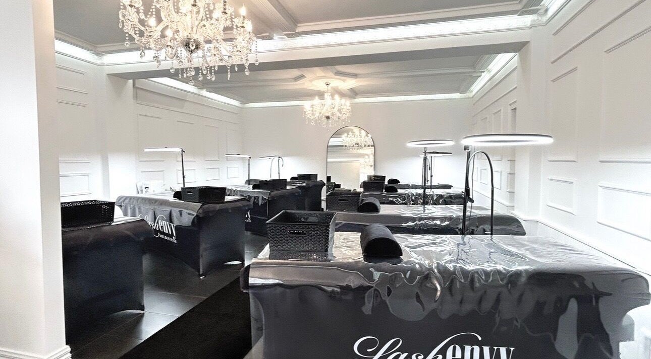 Elegant interiors of Lash Envy | Geelong in Geelong West, Victoria, AU featuring chandeliers and treatment stations.