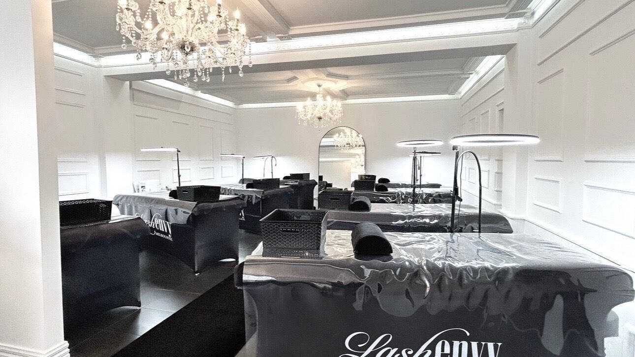 Elegant interiors of Lash Envy | Geelong in Geelong West, Victoria, AU featuring chandeliers and treatment stations.
