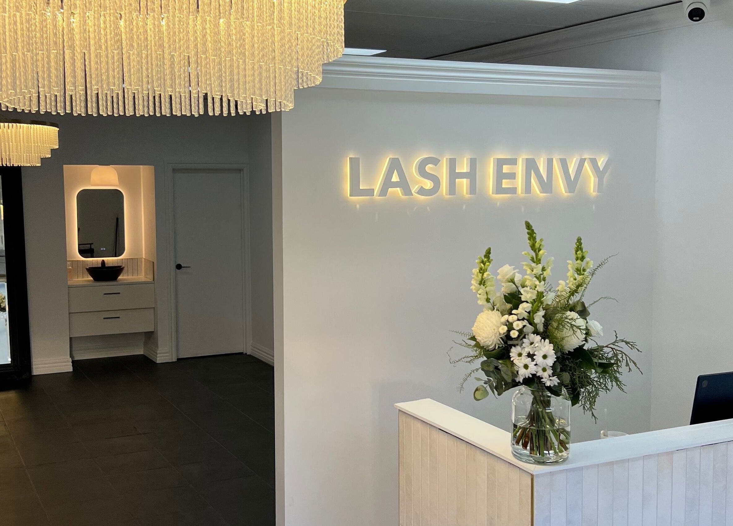 Chic reception at Lash Envy | Geelong West, Victoria, AU, with stunning chandeliers and floral decor.