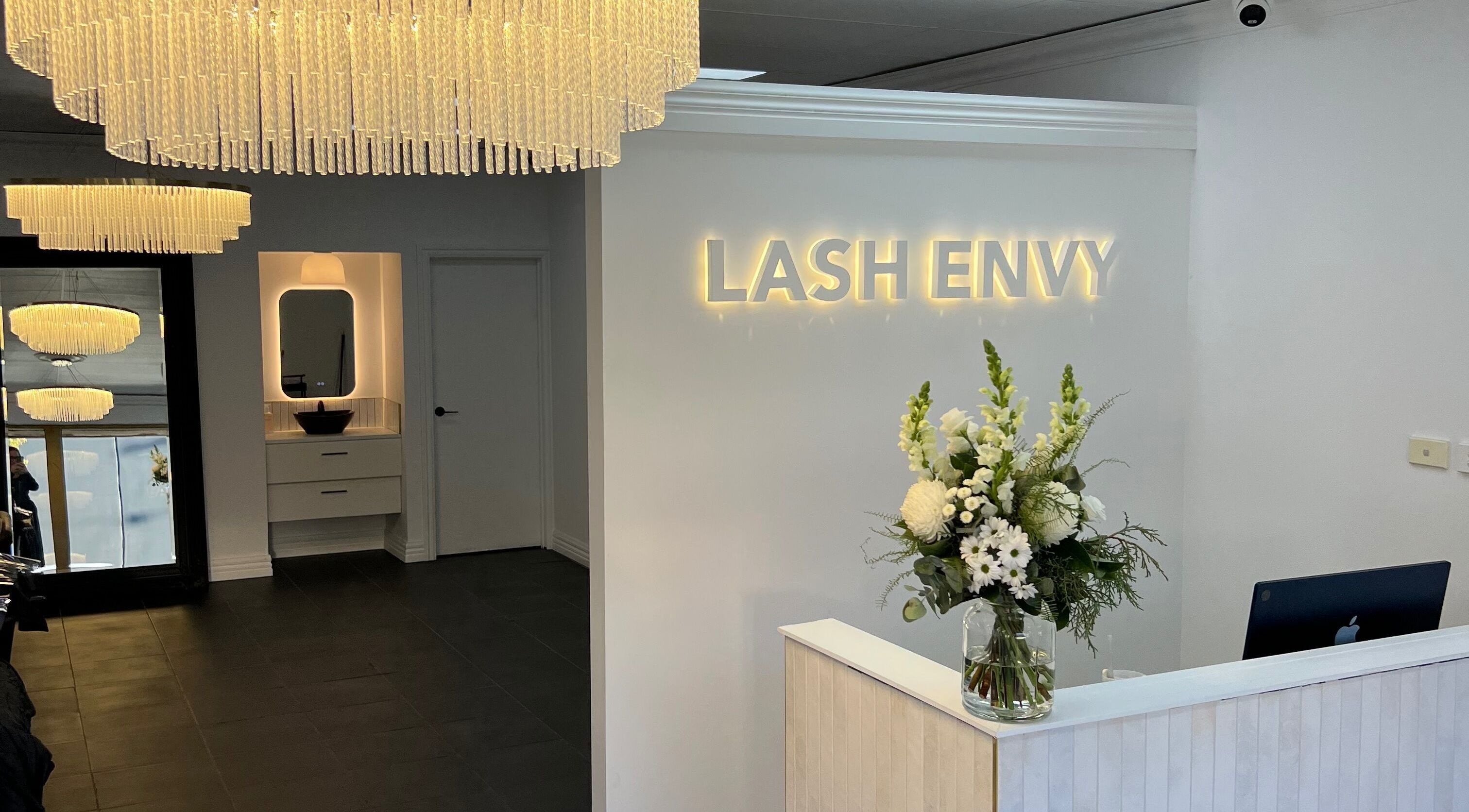 Chic reception at Lash Envy | Geelong West, Victoria, AU, with stunning chandeliers and floral decor.