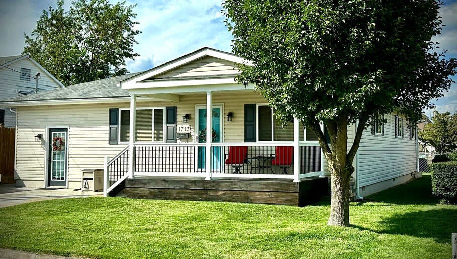 Charming white exterior of SeptemberS Salon - Nitro, Nitro, West Virginia, US, with lush green lawn.