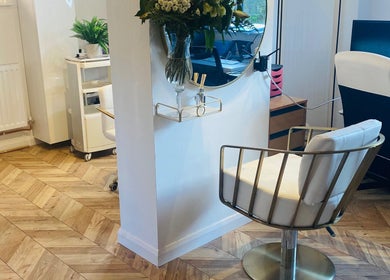 Elegant interior of Hairworkz Hairdressing in Rode Heath, England, GB featuring stylish seating and decor.