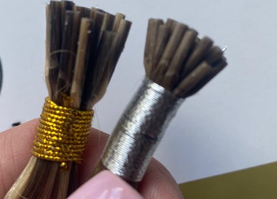 Close-up of hair strands with gold and silver wrapping at Hairworkz Hairdressing, Rode Heath, England, GB.