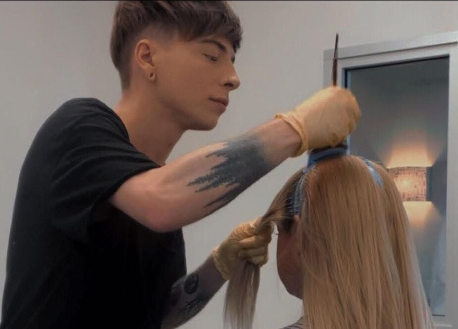 Stylist perfecting hairstyle at Leighton X Beauty, Chandler, Arizona, US.