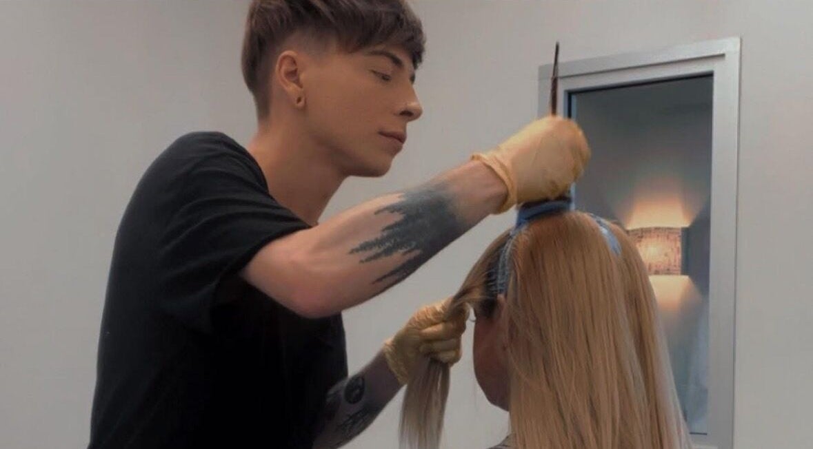 Stylist perfecting hairstyle at Leighton X Beauty, Chandler, Arizona, US.