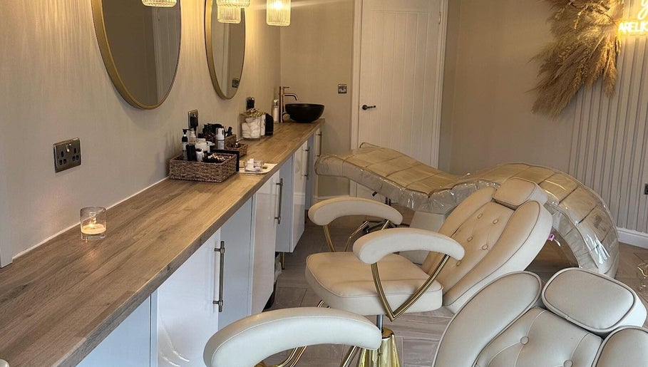 Chic treatment area at Eye Love Brows, Glasgow, Scotland, GB featuring plush chairs and ambient lighting.