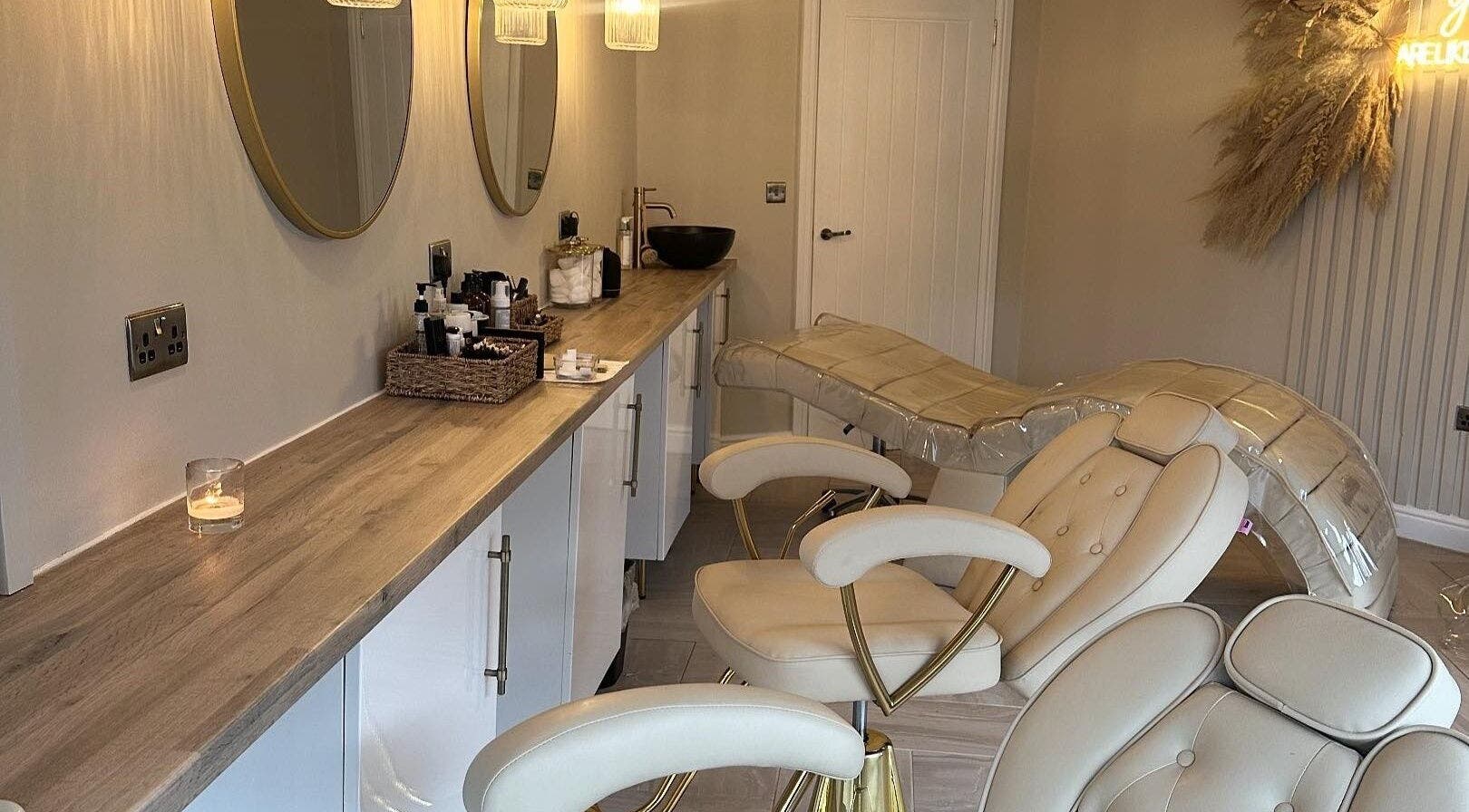 Chic treatment area at Eye Love Brows, Glasgow, Scotland, GB featuring plush chairs and ambient lighting.