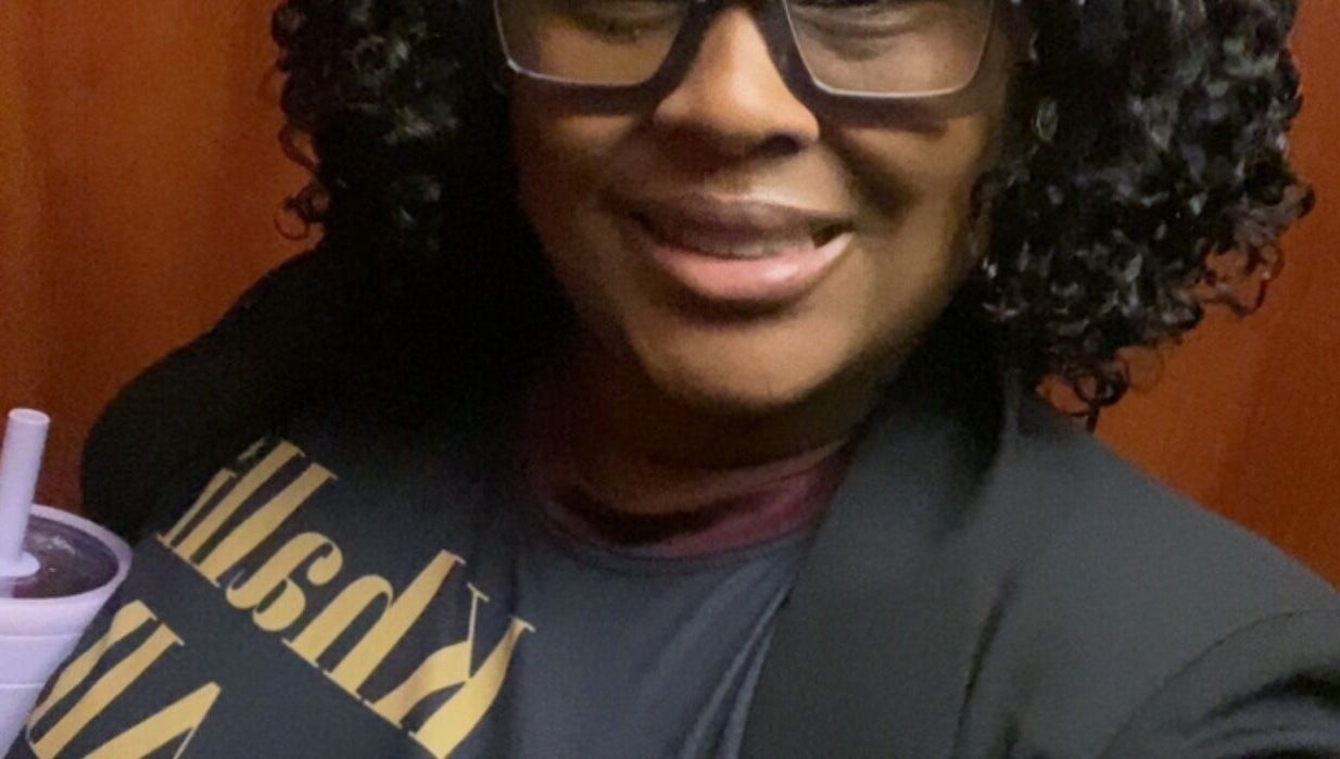 A smiling person in glasses at Khallin All Kurls Natural Kinks, New Port Richey, Florida, US.