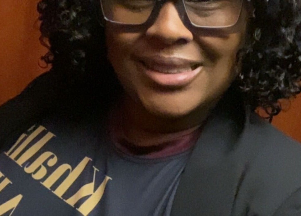 A smiling person in glasses at Khallin All Kurls Natural Kinks, New Port Richey, Florida, US.