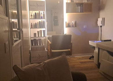The Hair Cabin in Featherstone, England, GB, showcasing a serene, stylish salon interior with product display.