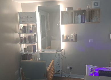 Cozy salon setup at The Hair Cabin, Featherstone, England, GB featuring hair products and a styling chair.