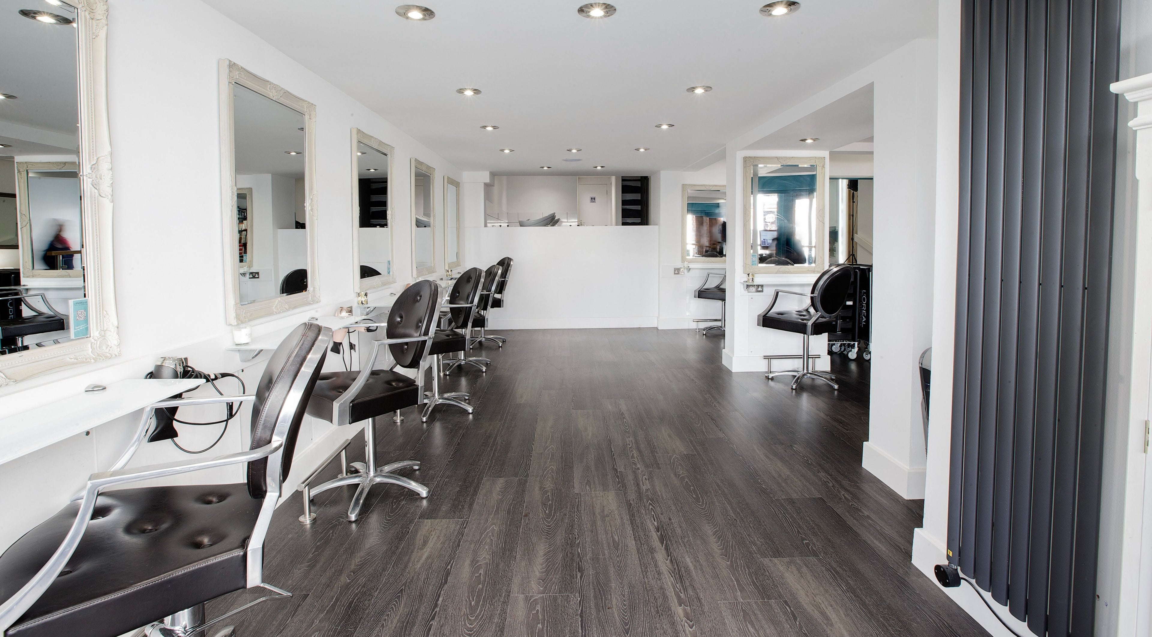 Stylish interior of Lifestyle Salons in Aylesbury, GB featuring elegant chairs and large mirrors.