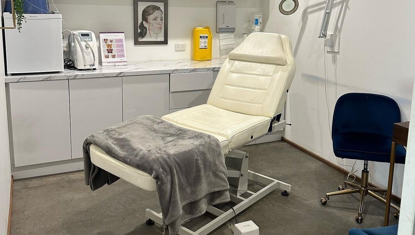 Treatment room at Feather and Arch Cosmetic Tattoo, Mooloolaba. Features a comfortable chair and modern decor.