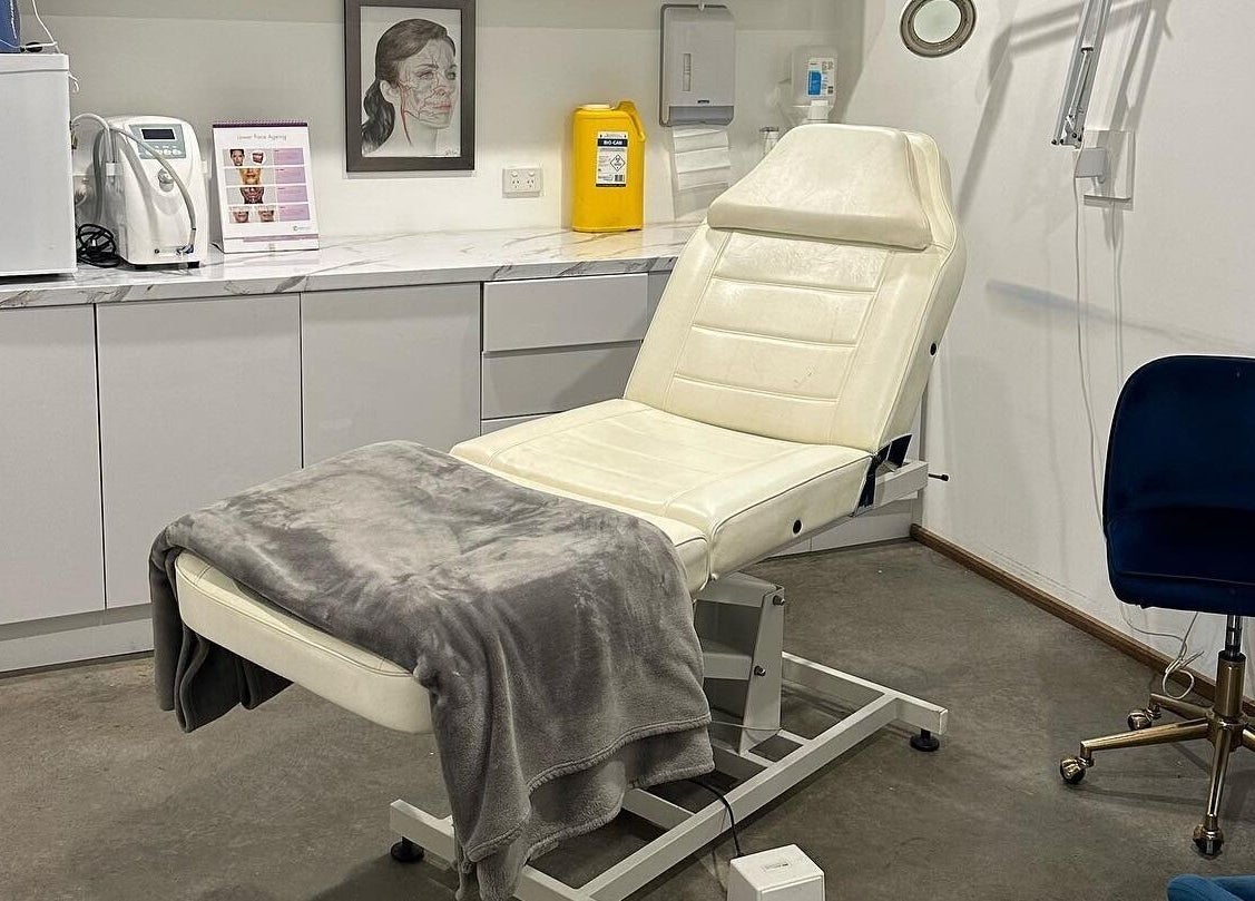 Treatment room at Feather and Arch Cosmetic Tattoo, Mooloolaba. Features a comfortable chair and modern decor.