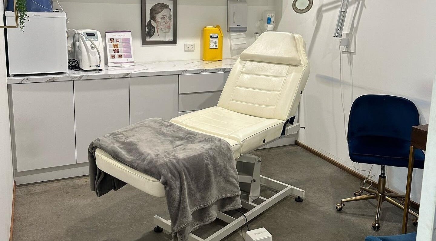 Treatment room at Feather and Arch Cosmetic Tattoo, Mooloolaba. Features a comfortable chair and modern decor.