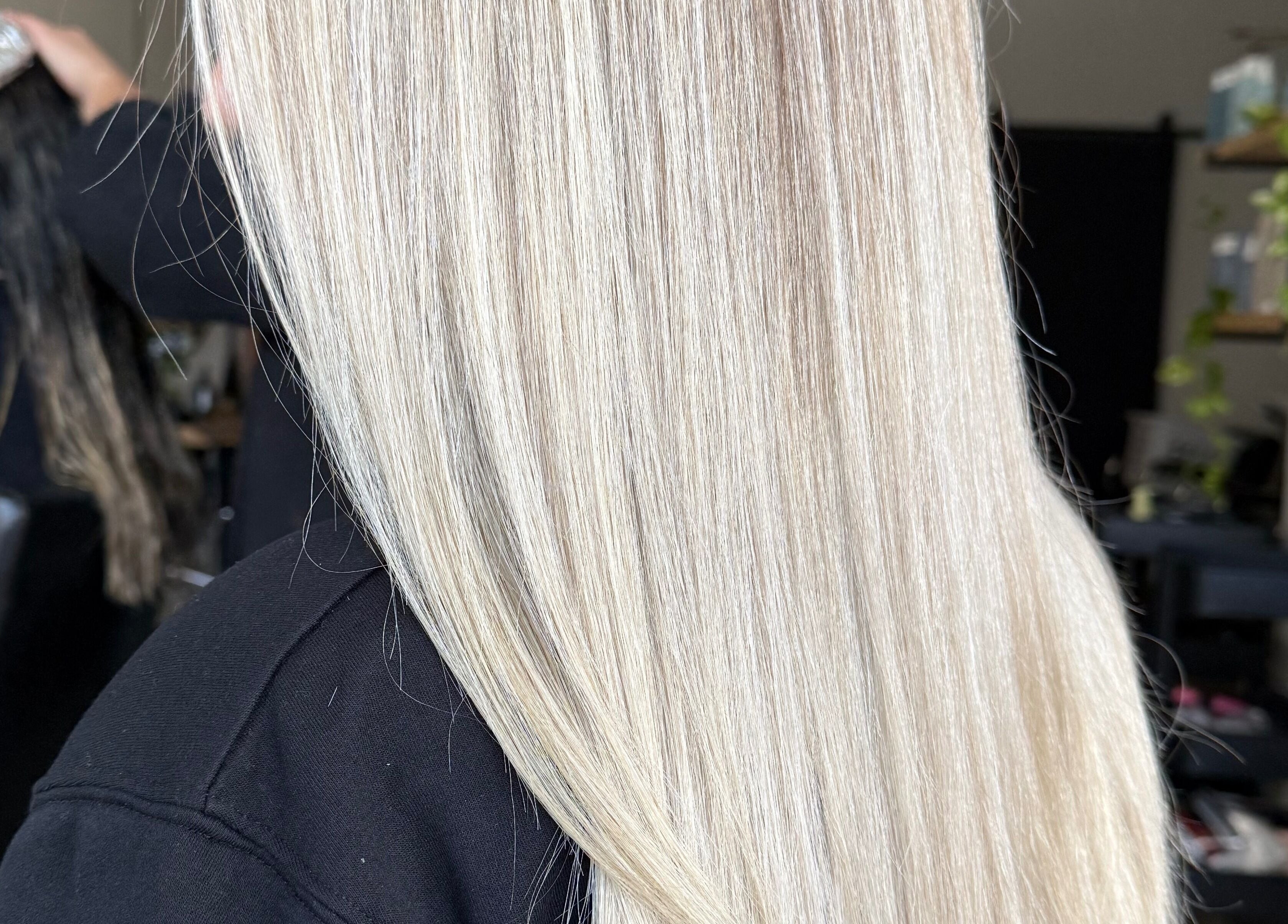 Sleek blonde hair styling at Jazzy Cutz, St Catharines, Ontario, CA, highlighting smooth straight layers.