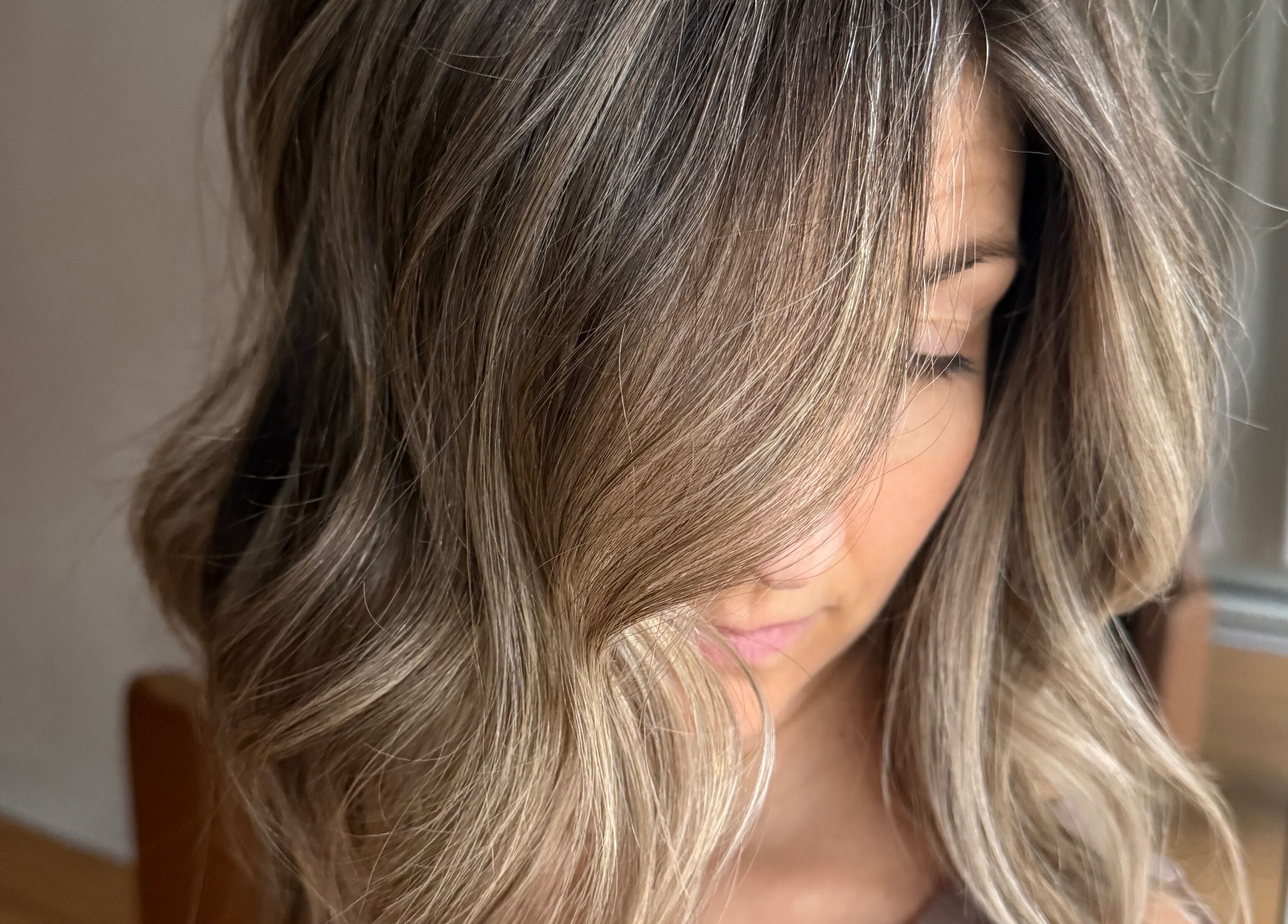 Stylish haircut at Jazzy Cutz in St Catharines, Ontario, CA, showcasing glossy highlighted waves.