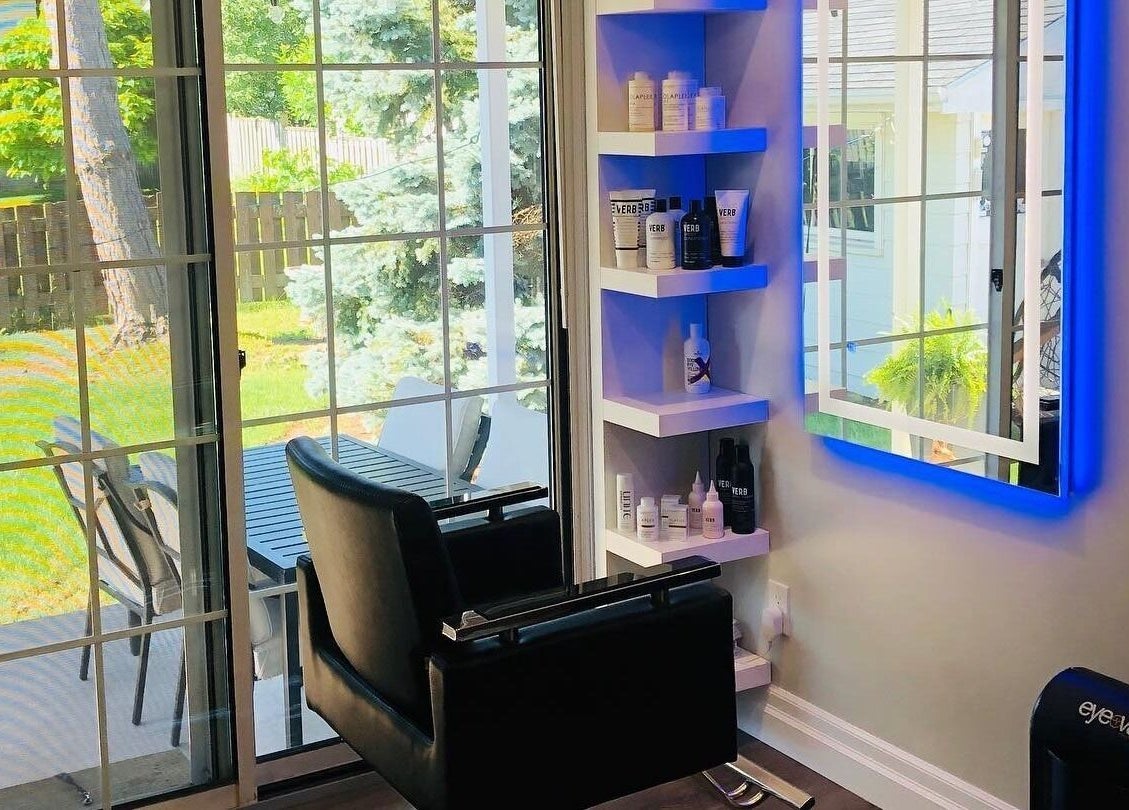 Interior view of Jazzy Cutz in St Catharines, Ontario, CA showcasing a modern salon setup next to a sunny window.