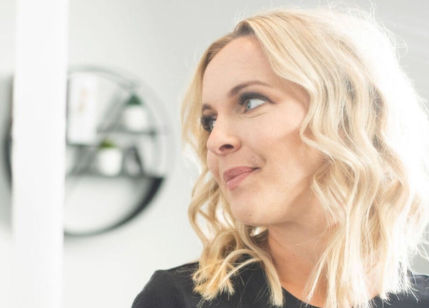 Stylish woman with wavy blonde hair at Jazzy Cutz, St Catharines, Ontario, CA.