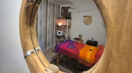Cozy massage room at HeartSpace Massage & Healing in Tallebudgera, Queensland, AU with warm decor and soothing ambiance.