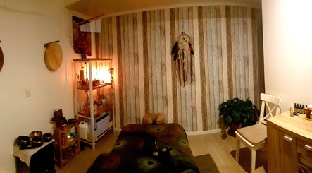 Cozy massage room at HeartSpace Massage & Healing, Tallebudgera, Queensland, AU, with dim lighting and decor.