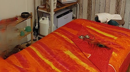 Relaxing massage room at HeartSpace Massage & Healing, Tallebudgera, Queensland, AU with a colorful massage bed.