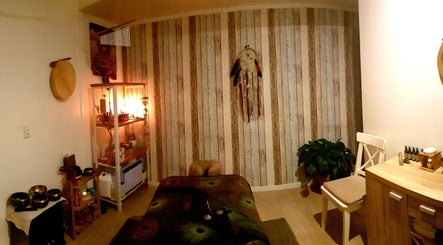 Cozy massage room at HeartSpace Massage & Healing in Tallebudgera, Queensland, AU, with ambient lighting.