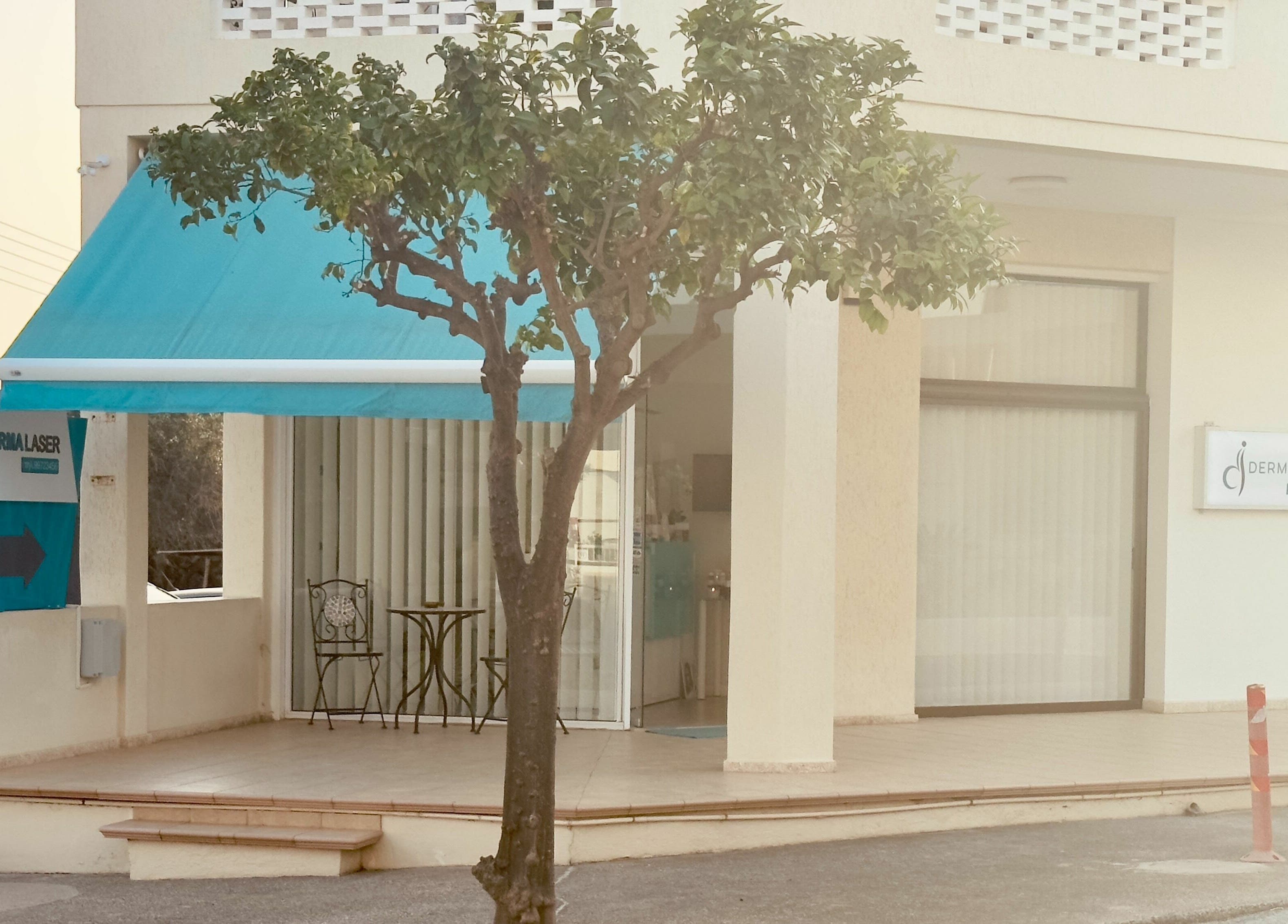 Entrance of Derma Laser Beauty Lounge with blue awning in Paralimni, Famagusta, CY.