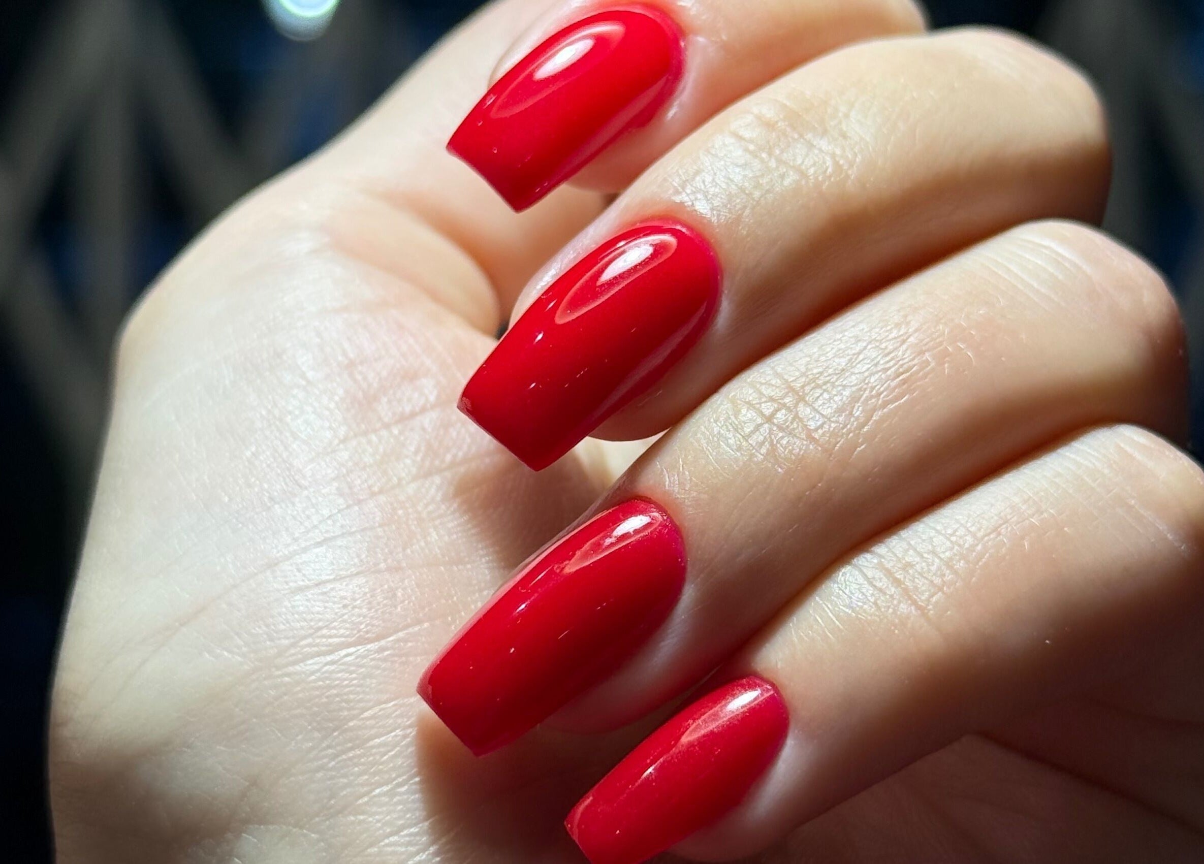 Close-up of vibrant red nails at BrowChuk by Vlada in London, England, GB.