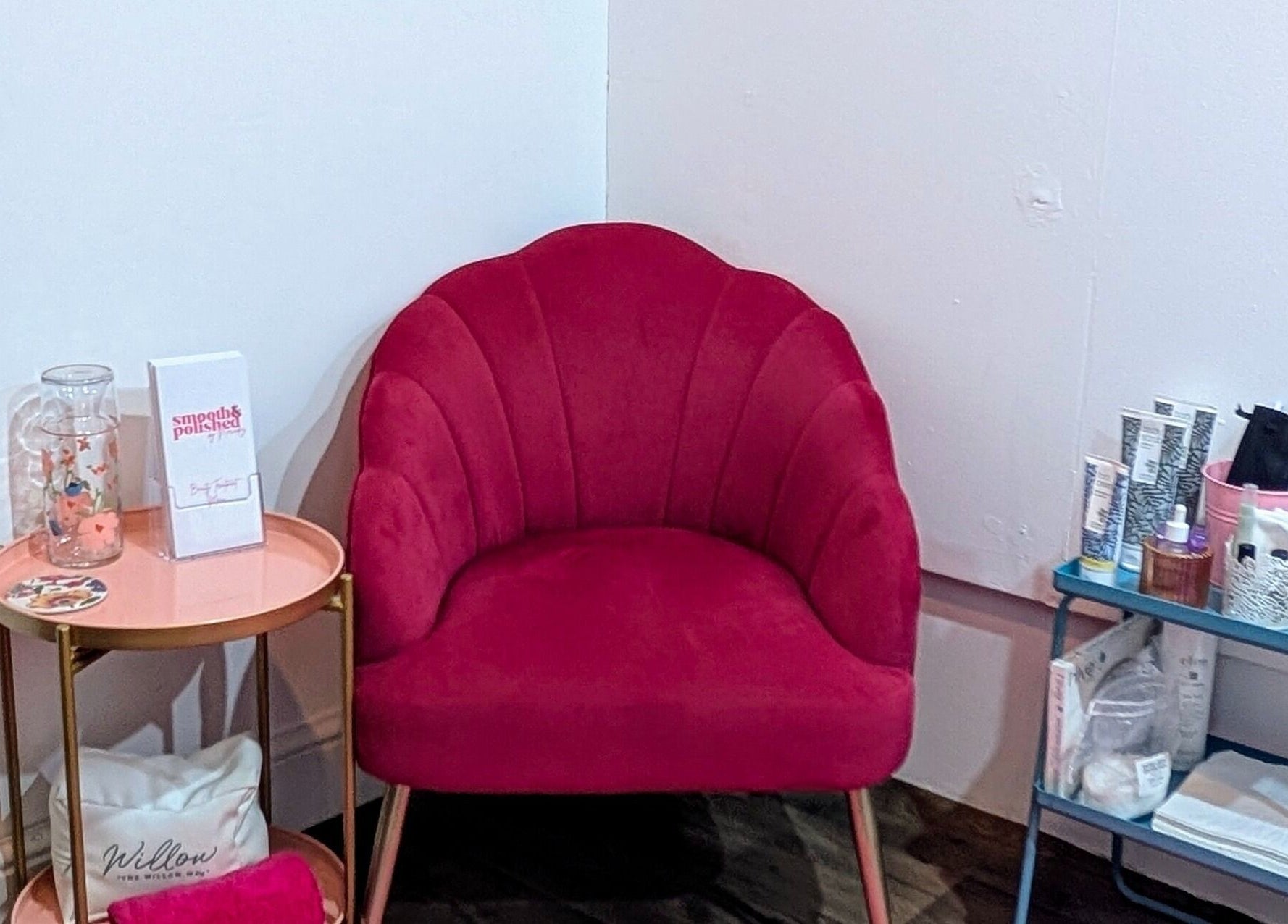 Chic seating area at Smooth & Polished by Mercedez in Swaffham, England, GB highlighting a red velvet chair.