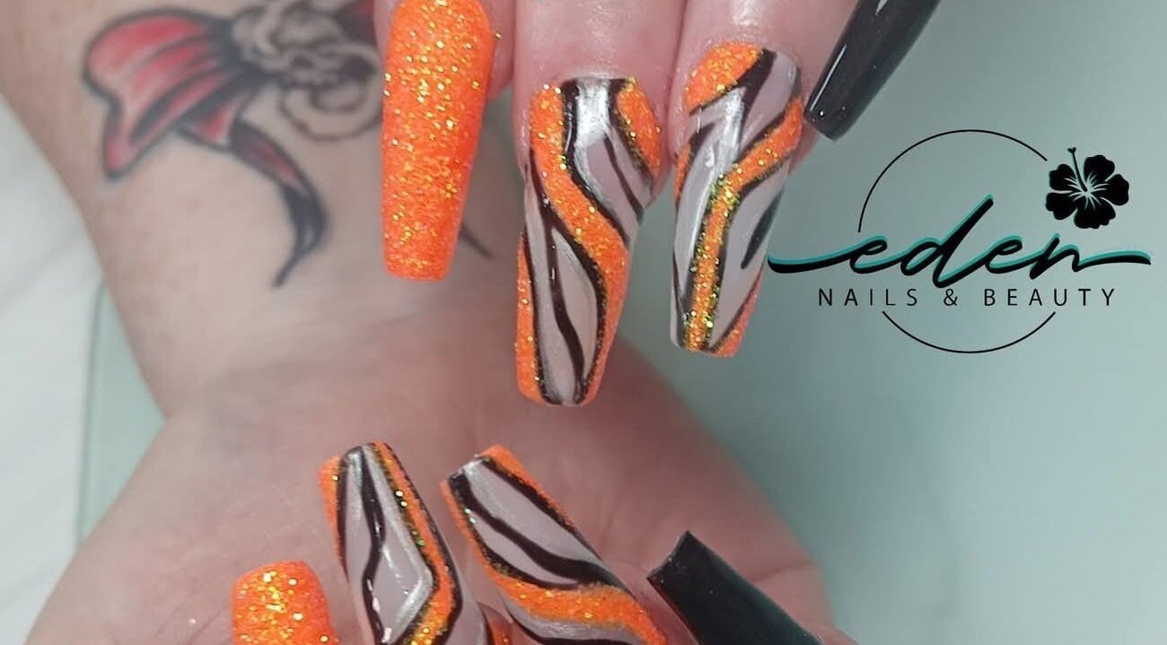Bold orange and black tiger stripe nail design at Eden Nails & Beauty, Glasgow, GB.