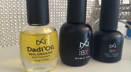 Nail care products at Eden Nails & Beauty in Glasgow, GB, featuring Dadi' Oil and IBX treatment bottles.