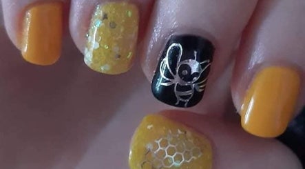 Bee-themed nail art in vibrant yellow and black at Eden Nails & Beauty, Glasgow, GB.